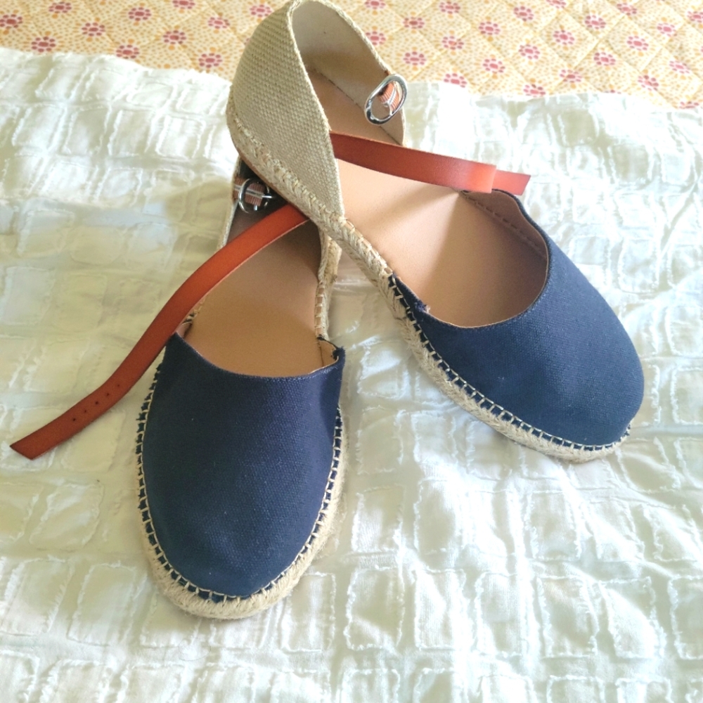 Navy and tan flats buckle around the ankles